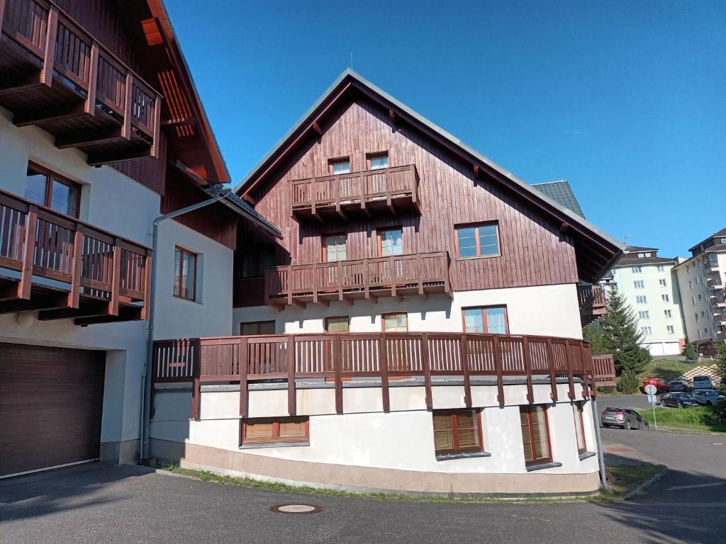 a house with wooden balconies on the side of it at Apartment Horní Rokytnice-2 by Interhome in Rokytnice nad Jizerou