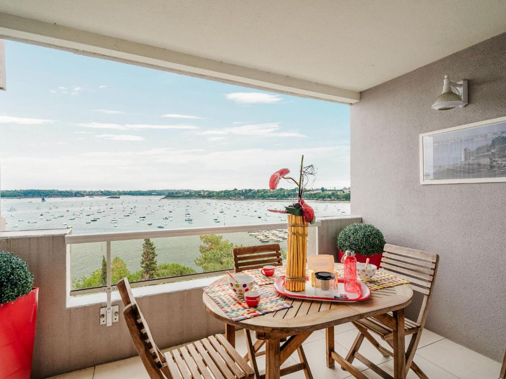 une table et des chaises sur un balcon avec vue sur l'eau dans l'établissement Apartment Terrasses d'Emeraude-7 by Interhome, à Dinard
