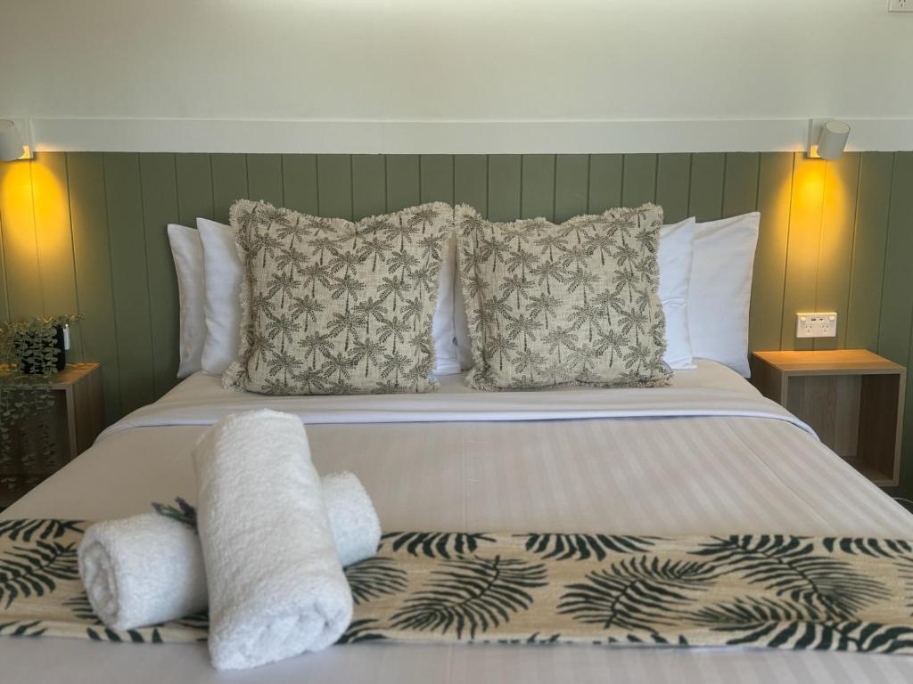 a bedroom with a bed with pillows at The Highlander Motel - 24HR Check In in Maryborough
