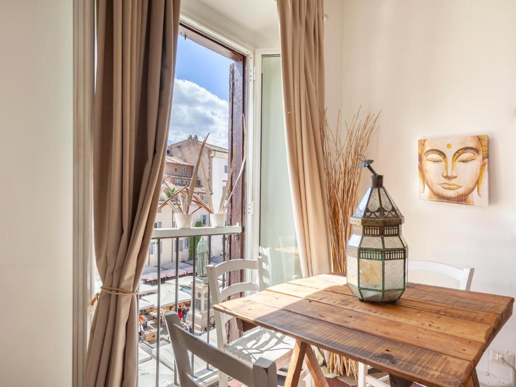 stół jadalny z widokiem na balkon w obiekcie Campo dei Fiori Holiday Home w Rzymie