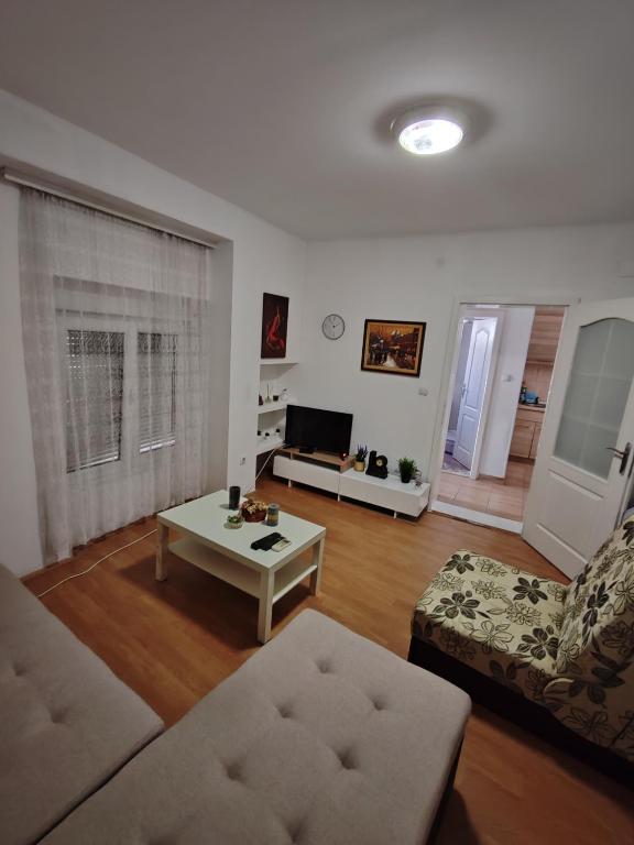 a living room with a couch and a coffee table at Happy house in Kruševac