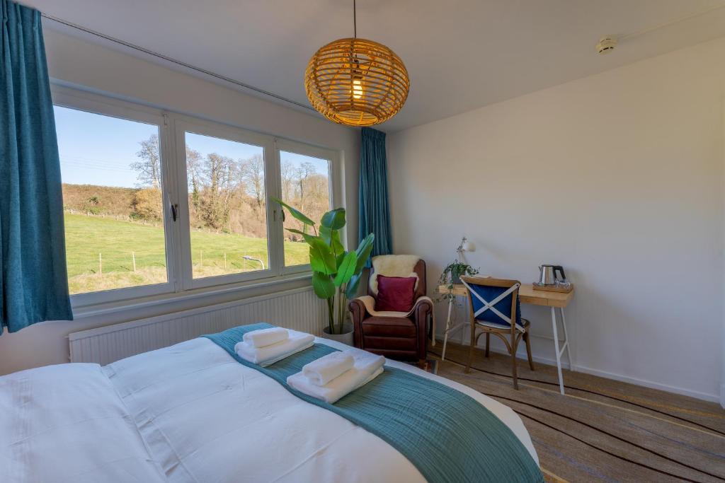 Ένα ή περισσότερα κρεβάτια σε δωμάτιο στο Geulzicht Hotel