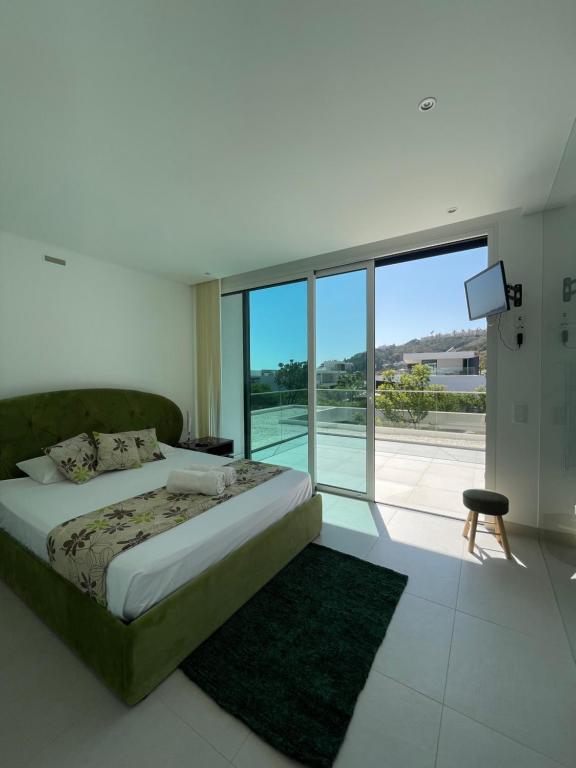 Casa Papoila في ألبوفيرا: غرفة نوم بها سرير ونافذة كبيرة