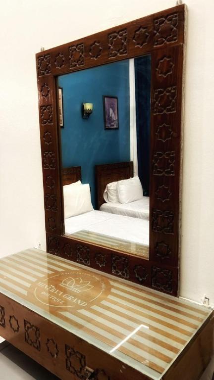 A bed or beds in a room at Minerva Grand Boutique
