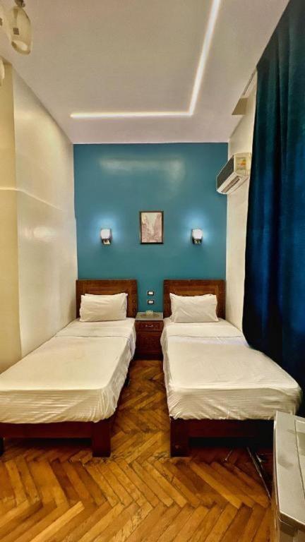 A bed or beds in a room at Minerva Grand Boutique