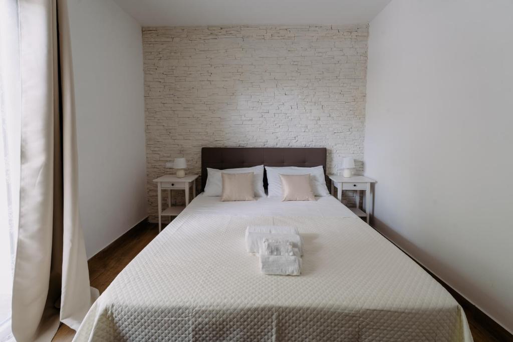 Postel nebo postele na pokoji v ubytování Franciacorta Rooms