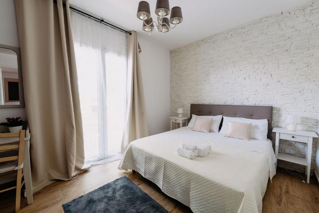 Postel nebo postele na pokoji v ubytování Franciacorta Rooms