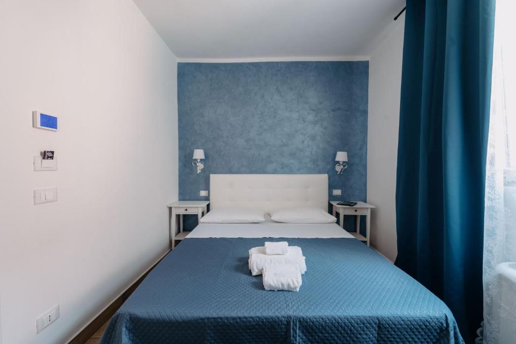 Postel nebo postele na pokoji v ubytování Franciacorta Rooms