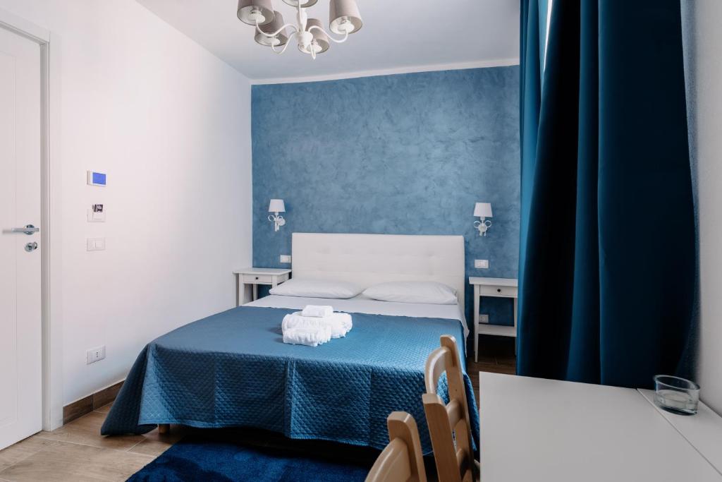 Postel nebo postele na pokoji v ubytování Franciacorta Rooms