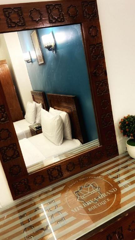 A bed or beds in a room at Minerva Grand Boutique