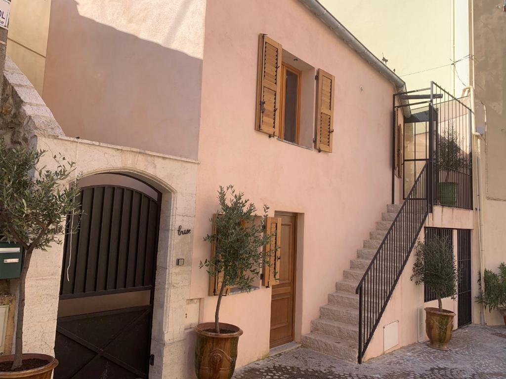 un bâtiment avec un escalier, une porte et quelques plantes dans l'établissement Chante Brise 2 Pieces, à Cannes