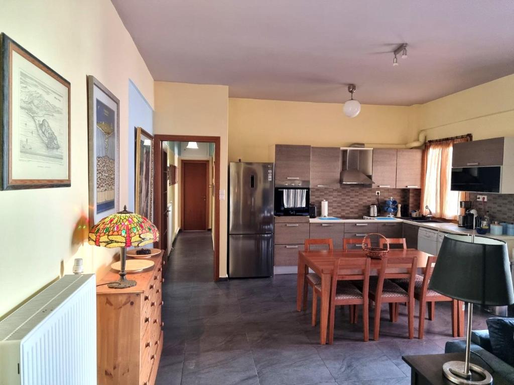a kitchen and dining room with a table and refrigerator at Syros 41 in Ermoupoli