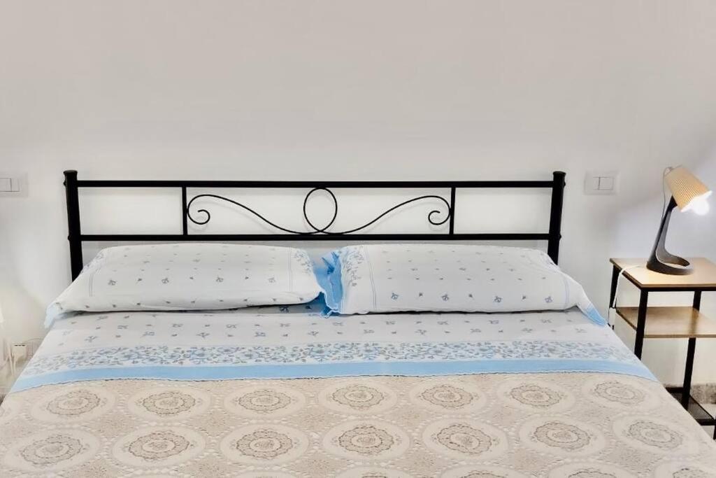 a bedroom with a bed with a black headboard at La casa di mammona in Semivicoli