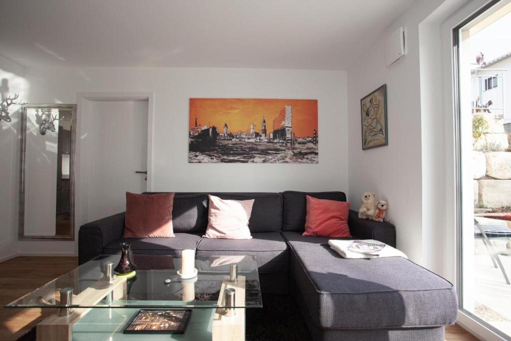 a living room with a couch and a glass table at Ferienwohnung Will in Bodman-Ludwigshafen