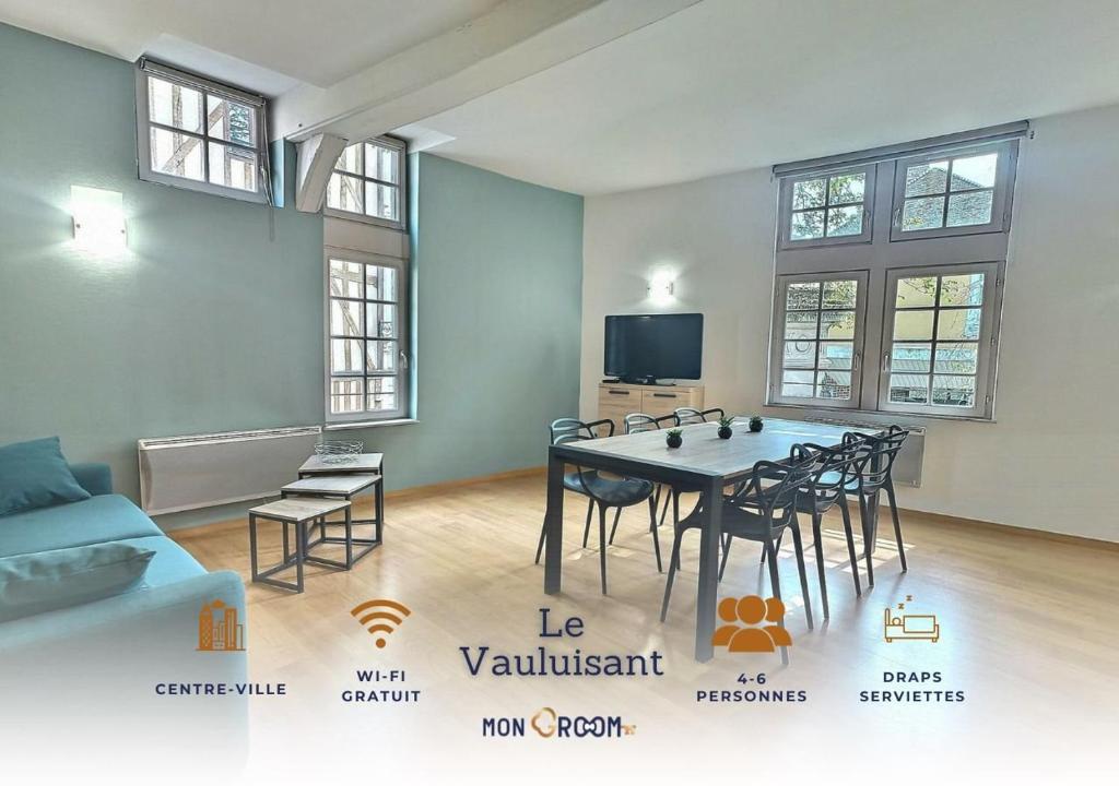 a living room with a dining room table and chairs at Le Vauluisant | Appartement Confort | Mon Groom in Troyes