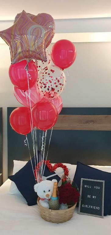 a basket of red balloons and a teddy bear in a basket of flowers at The Paramount and The Supreme at Bellamare in Summerstrand