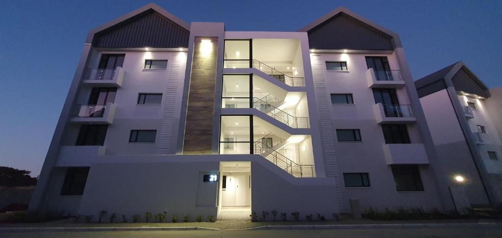 a large white building with a door at night at The Paramount and The Supreme at Bellamare in Summerstrand