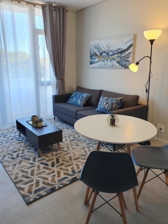 a living room with a couch and a table at The Paramount and The Supreme at Bellamare in Summerstrand