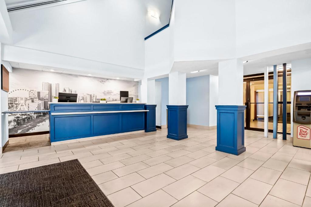 a lobby of a office with a blue reception desk at Red Roof Inn Myrtle Beach Hotel - Market Commons in Myrtle Beach