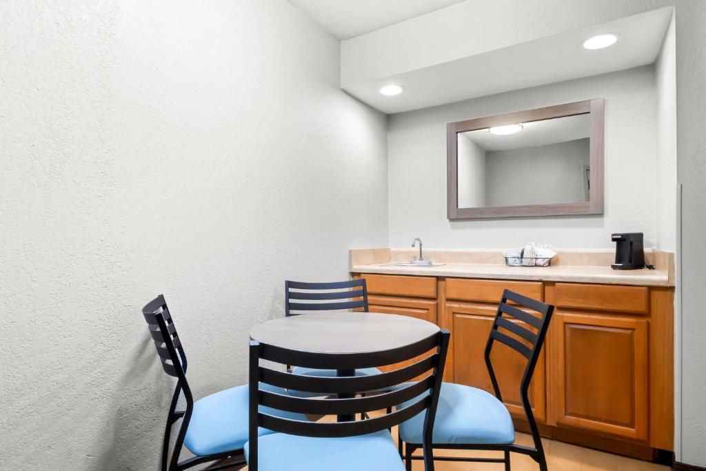 a room with a table and chairs and a sink at Red Roof Inn Myrtle Beach Hotel - Market Commons in Myrtle Beach