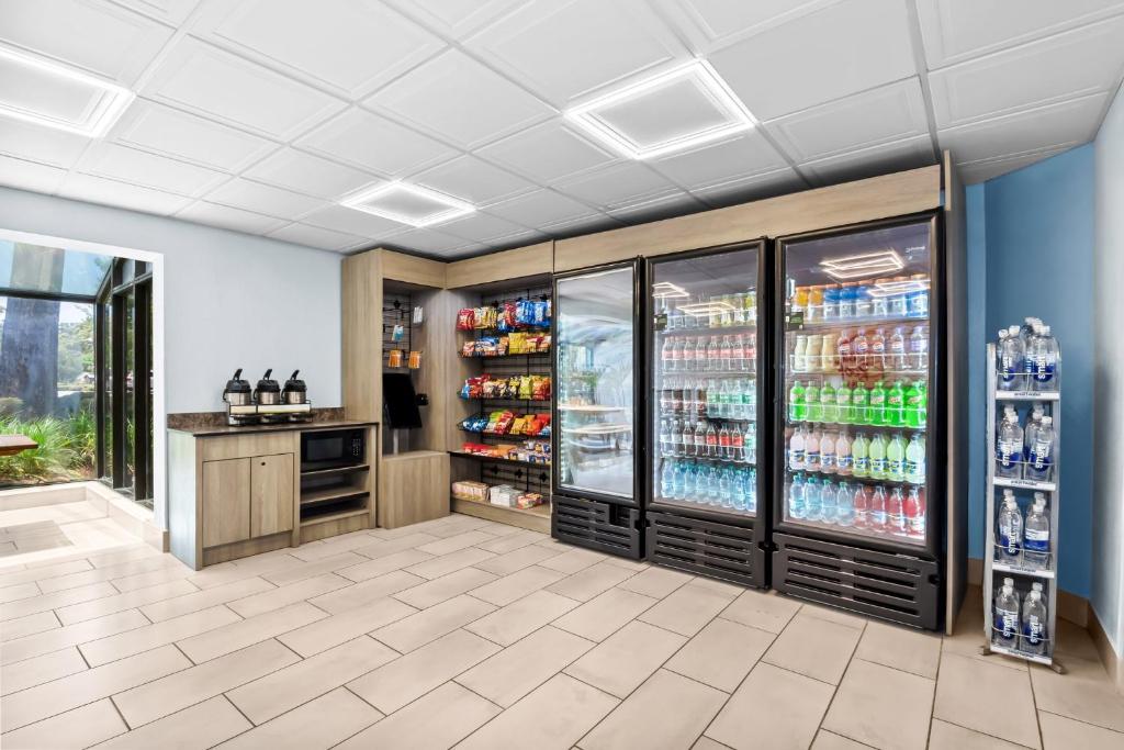 a drink station in a grocery store with a drink refrigerator at Red Roof Inn Myrtle Beach Hotel - Market Commons in Myrtle Beach