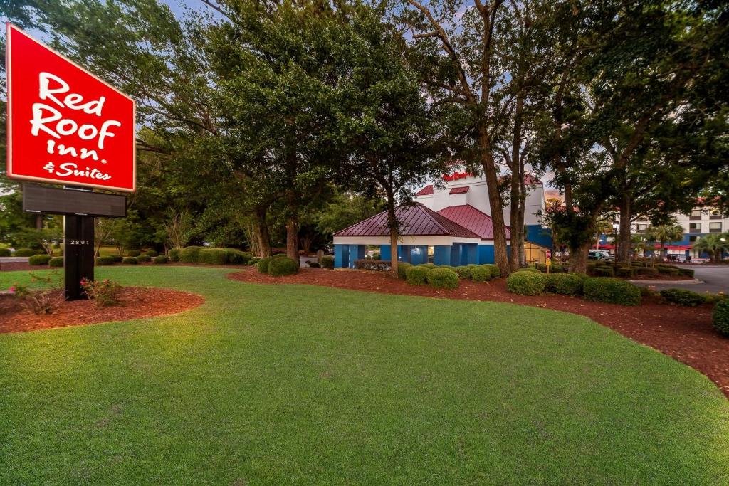 a red roof inn and shuttle sign in a park at Red Roof Inn Myrtle Beach Hotel - Market Commons in Myrtle Beach