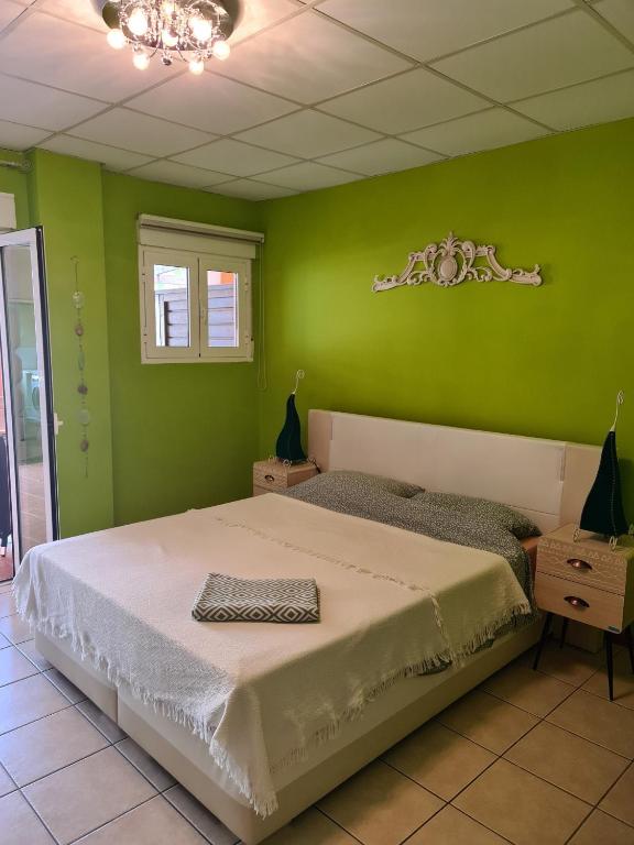 a bedroom with a bed in a green wall at Die kleine Auszeit in Denia