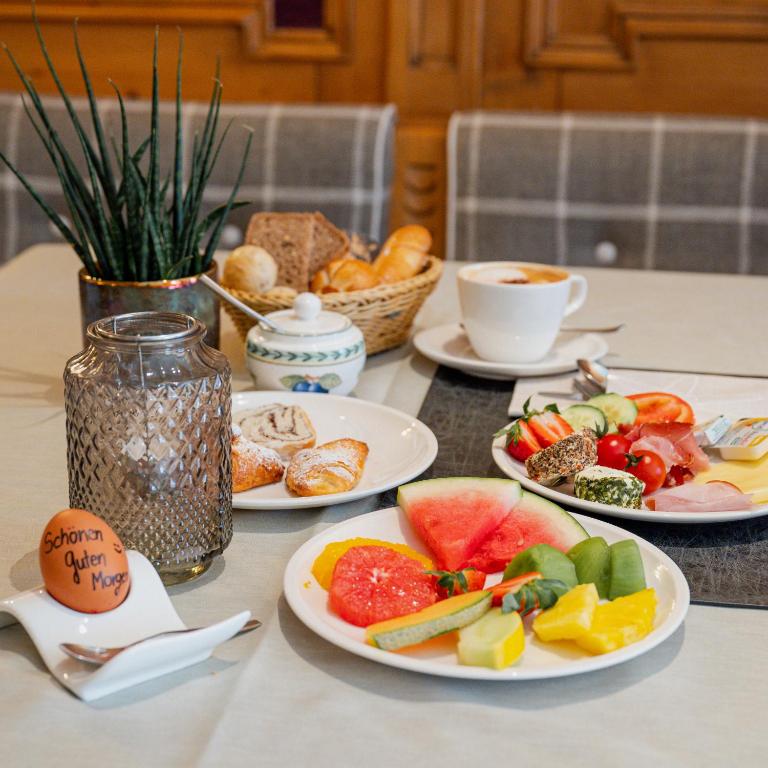 a table with three plates of food on it at Alpenhotel Montafon & SPA in Schruns