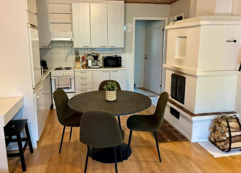 a kitchen with a table and chairs in a kitchen at Talitintti Levi, 1 bedroom apartment, family friendly in Levi