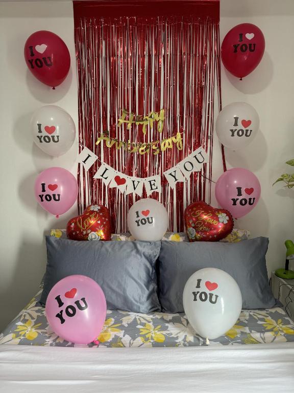 a bed with lots of hello kitty balloons on it at Vinia Infinity Studio 1 Near Malls with WiFi and Netflix in Manila