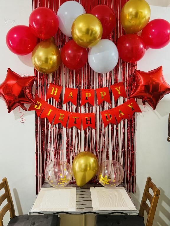 a table with a bunch of balloons and wine glasses at Vinia Infinity Studio 1 Near Malls with WiFi and Netflix in Manila