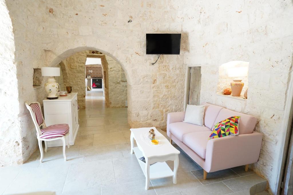 un salon avec un canapé et une table dans l'établissement Trullo Le Rondinelle, à San Michele Salentino