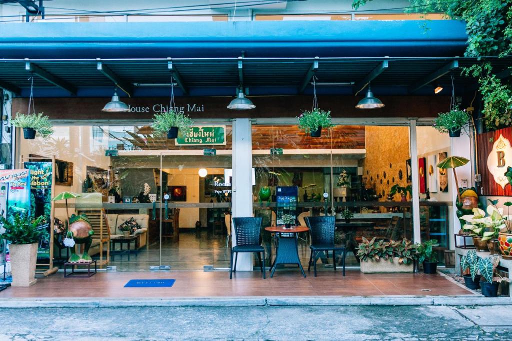 a restaurant with chairs and a table in front of it at B House Chiang Mai Thailand in Chiang Mai