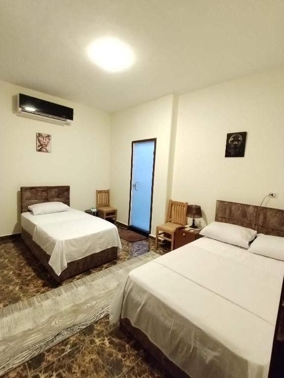 Postel nebo postele na pokoji v ubytování El Khalil Pyramids View Inn