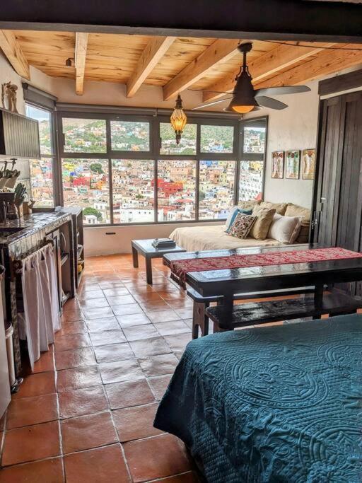 a living room with a couch and a table at Spacious Studio Boasting Breathtaking Views in Guanajuato