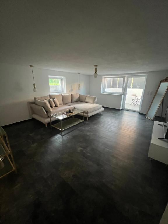 a living room with a couch and a table at Gemütlich Wohnen Sinsheim 2 in Sinsheim
