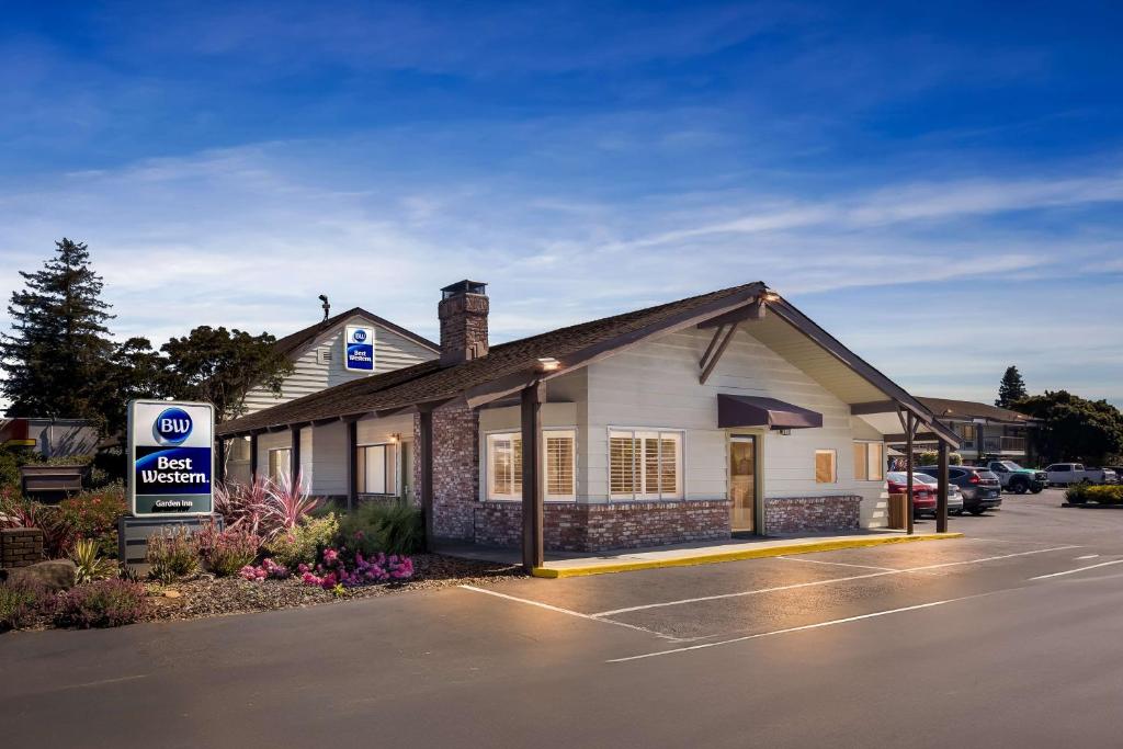 a building with a sign in a parking lot at Best Western Garden Inn in Santa Rosa