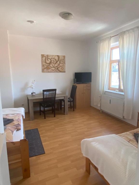 a bedroom with a desk and a table with a chair at Wunderschönes Appartement Nahe der Berge in Bruckmühl