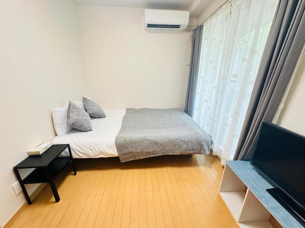 Postel nebo postele na pokoji v ubytování シャンテ高田馬場32