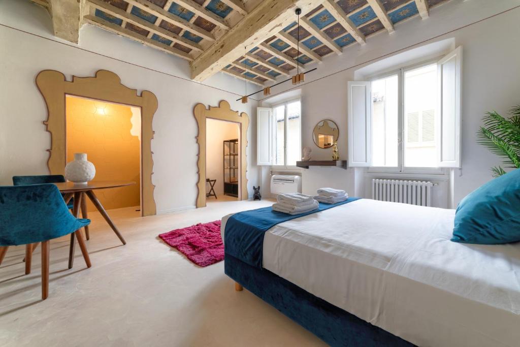 a bedroom with a bed and a desk and a mirror at ALFANI DUOMO Suite in Florence