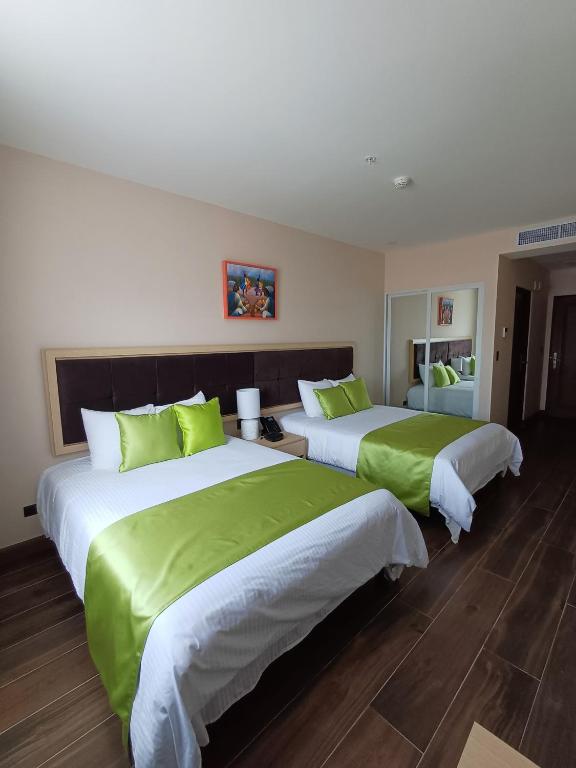 Postel nebo postele na pokoji v ubytování Hotel Puerto Limón CR