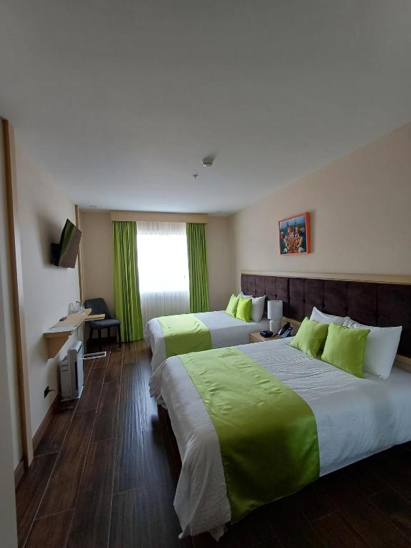 Postel nebo postele na pokoji v ubytování Hotel Puerto Limón CR