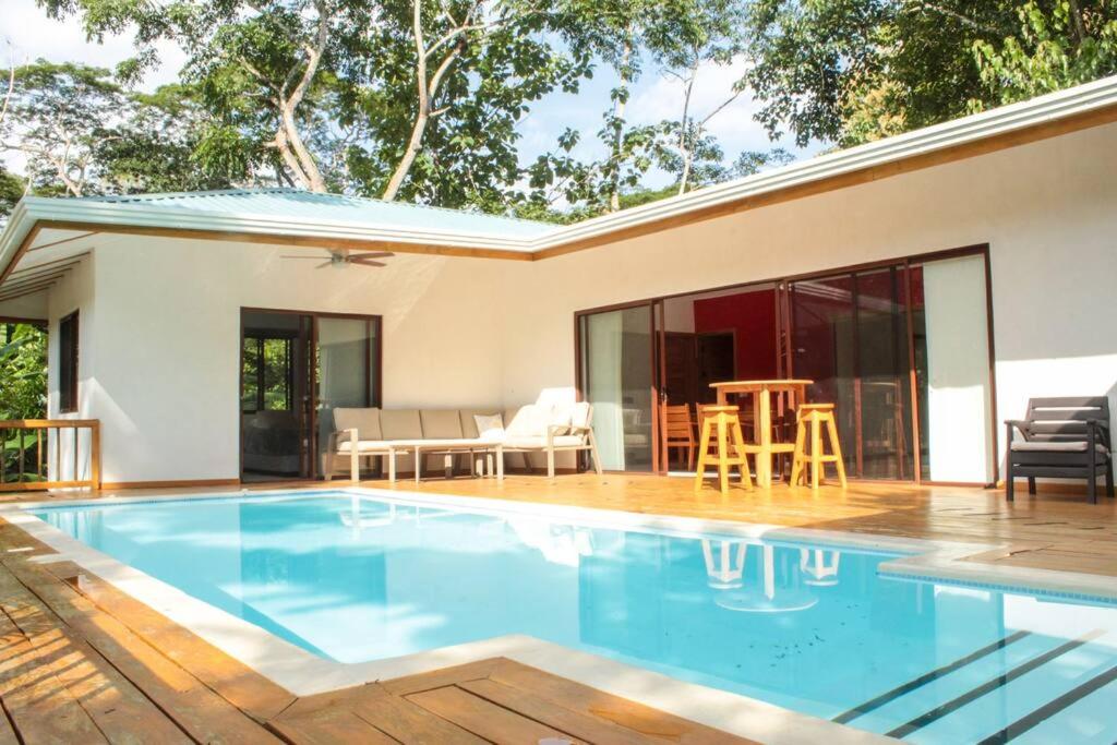 a house with a swimming pool and a patio at Casa Manzanillo Surf in Boca de Ario
