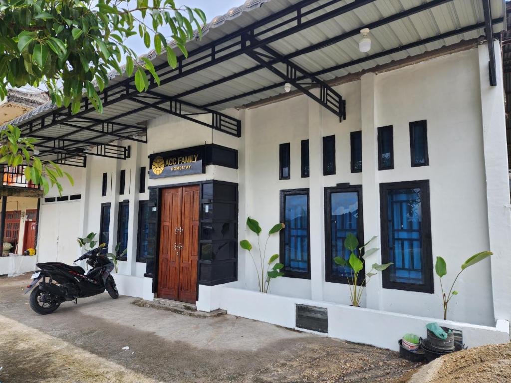 a motorcycle parked in front of a building at Acc Family Homestay in Takengon