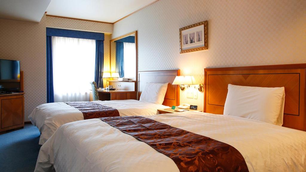 Postel nebo postele na pokoji v ubytování Hotel BELLMARE ホテルベルマーレ