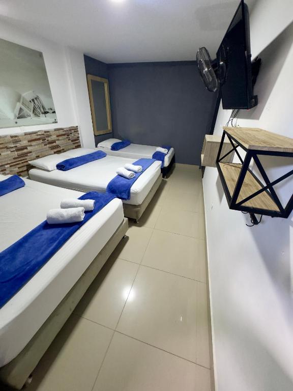 Postel nebo postele na pokoji v ubytování Hotel Select Medellin