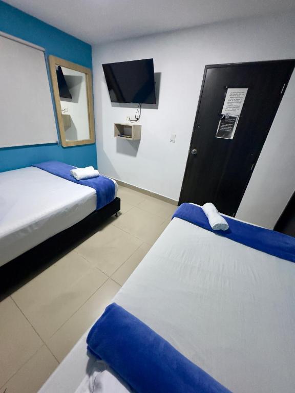 Postel nebo postele na pokoji v ubytování Hotel Select Medellin