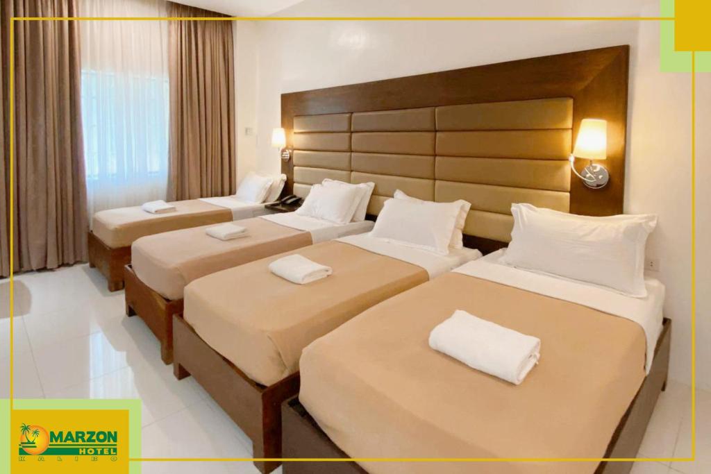 Postel nebo postele na pokoji v ubytování MARZON HOTEL KALIBO