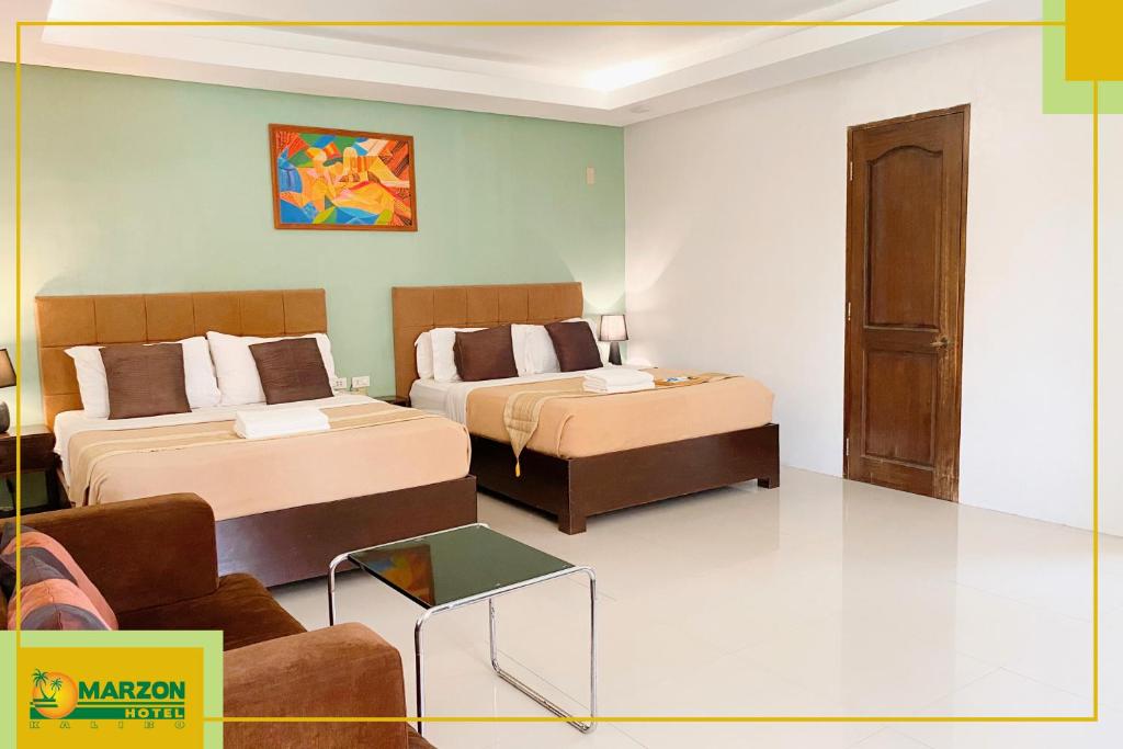 Postel nebo postele na pokoji v ubytování MARZON HOTEL KALIBO