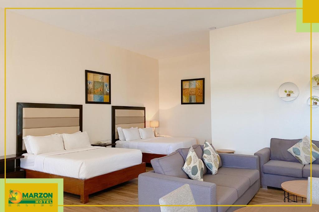 Postel nebo postele na pokoji v ubytování MARZON HOTEL KALIBO